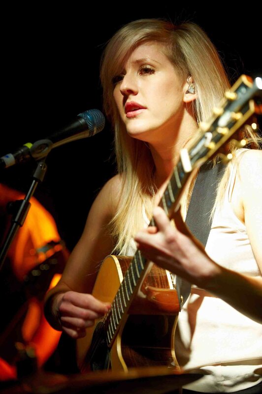 woman playing acoustic guitar