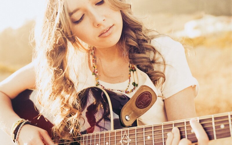 woman playing acoustic guitar