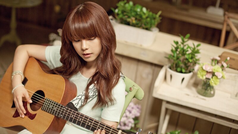 woman playing acoustic guitar