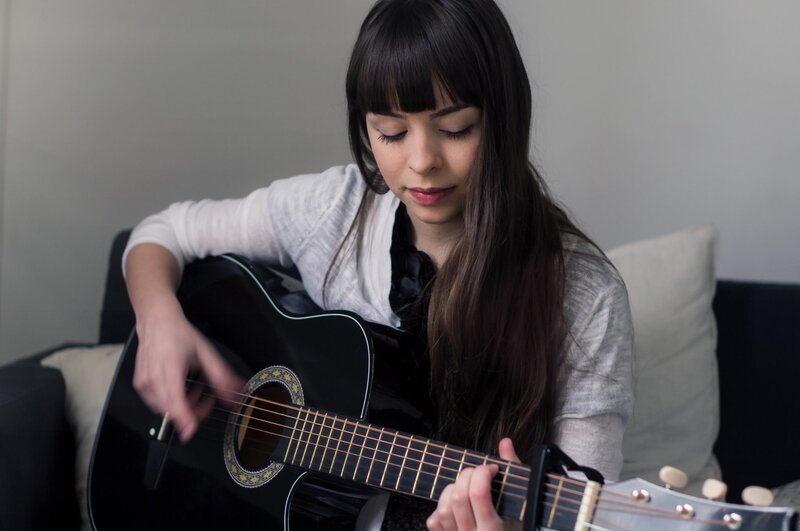 woman playing acoustic guitar