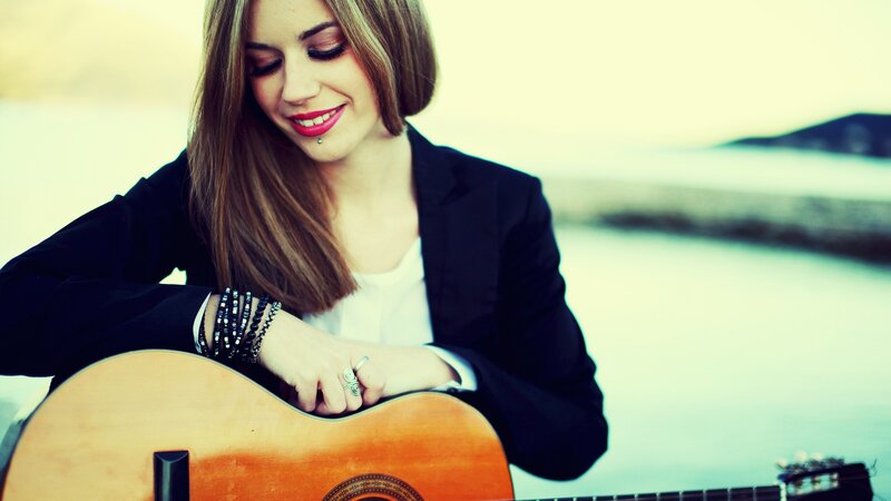 woman playing acoustic guitar