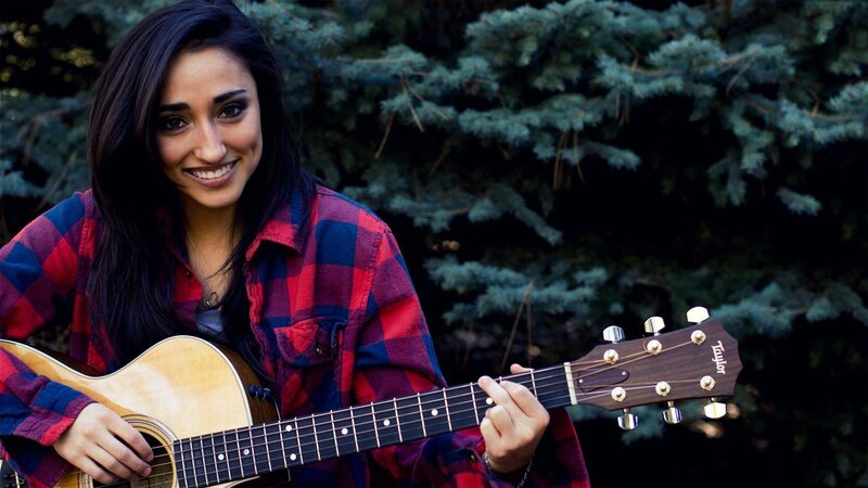 woman playing acoustic guitar