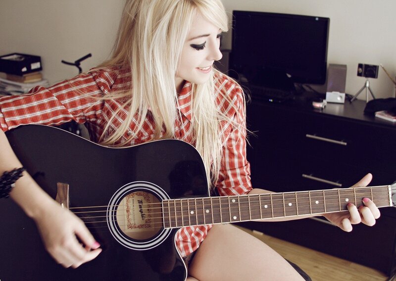 woman playing acoustic guitar