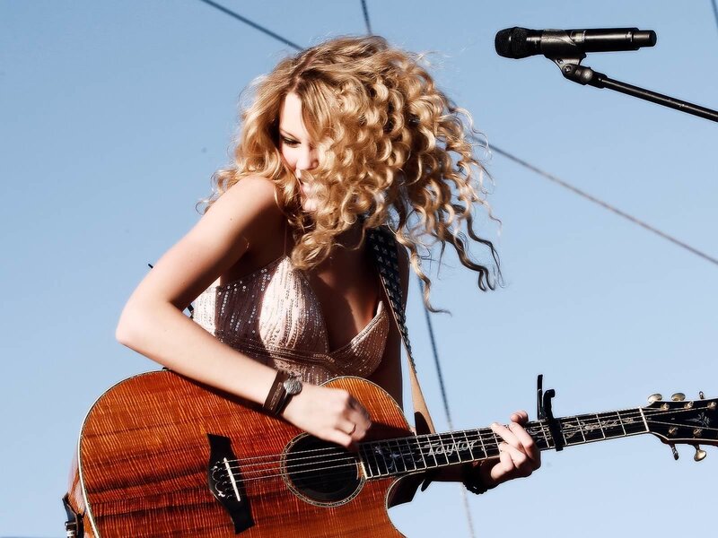 woman playing acoustic guitar