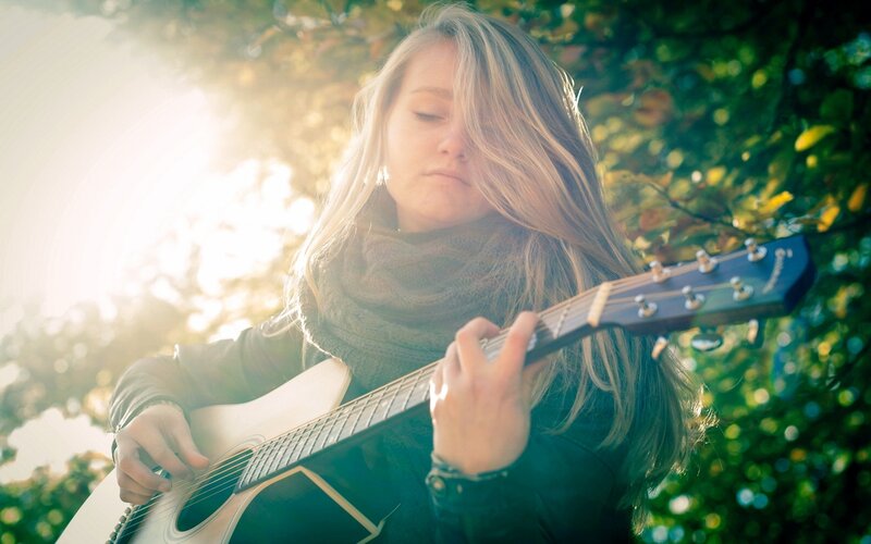 woman playing acoustic guitar
