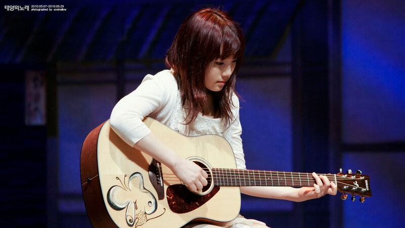 Woman Playing Acoustic Guitar — Blue