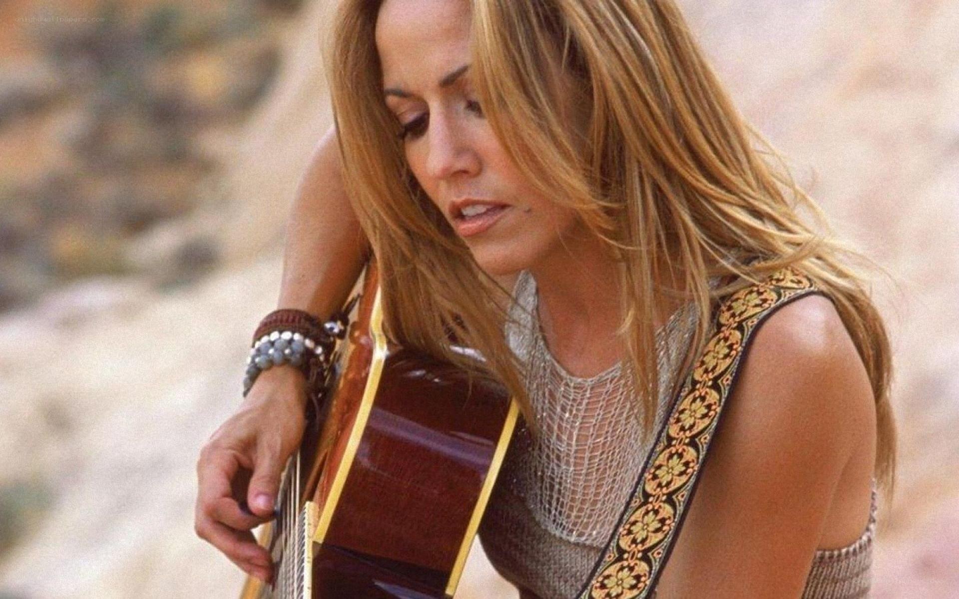 woman playing acoustic guitar