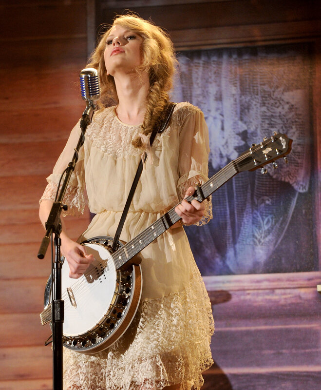 woman playing banjo on stage