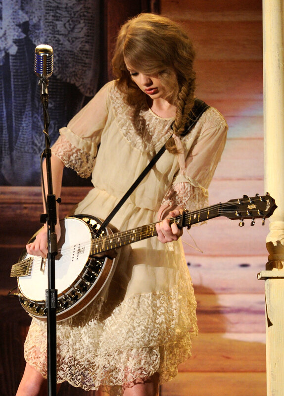 woman playing banjo on stage