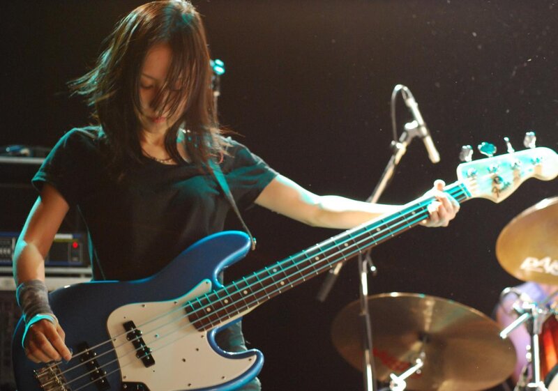woman playing bass guitar