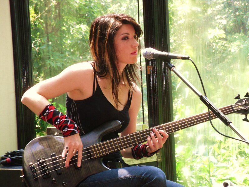 woman playing bass guitar