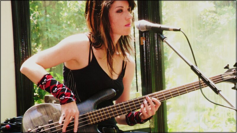 woman playing bass guitar