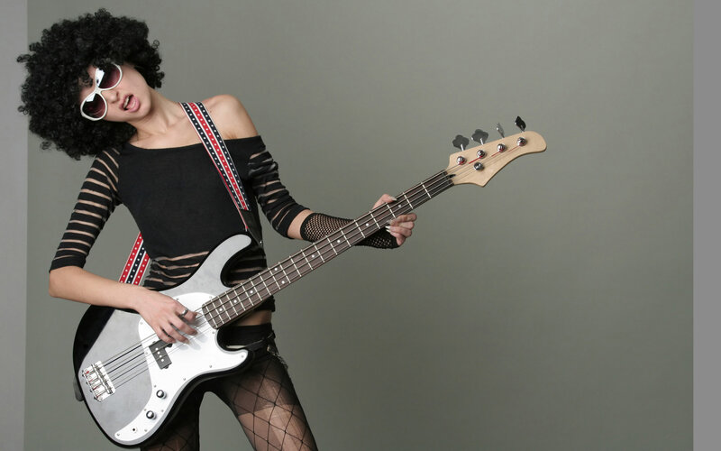 woman playing bass guitar
