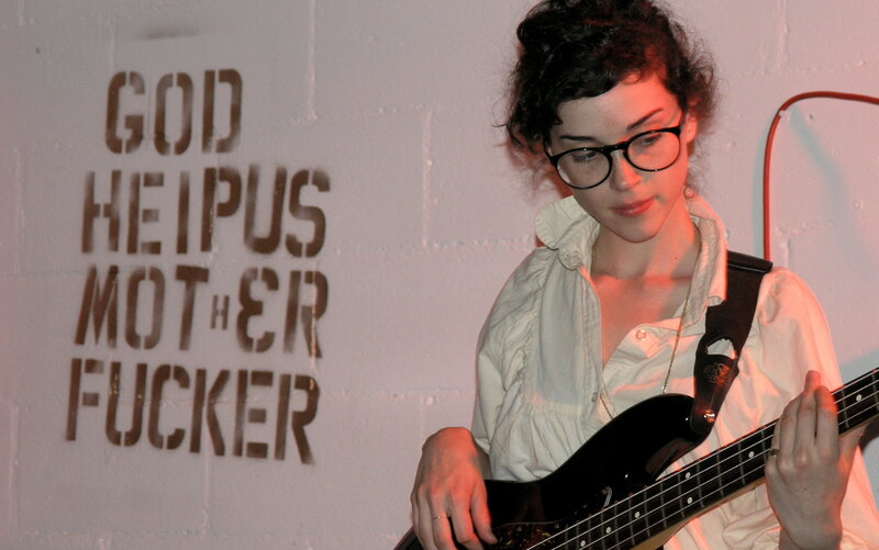 woman playing bass guitar