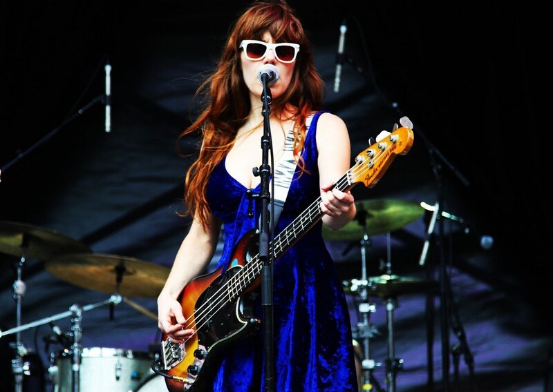 Woman playing bass guitar on stage
