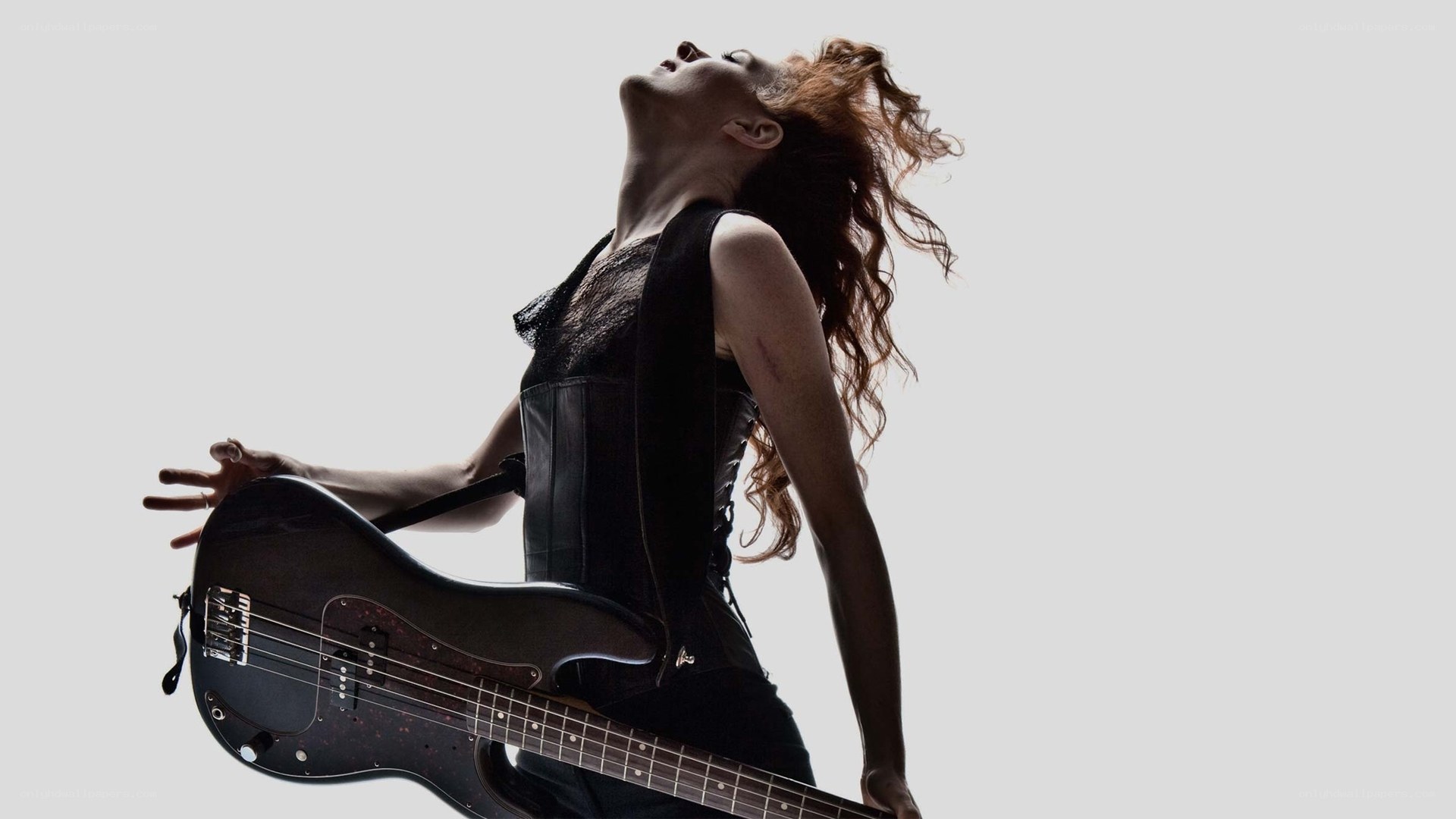 woman playing bass guitar