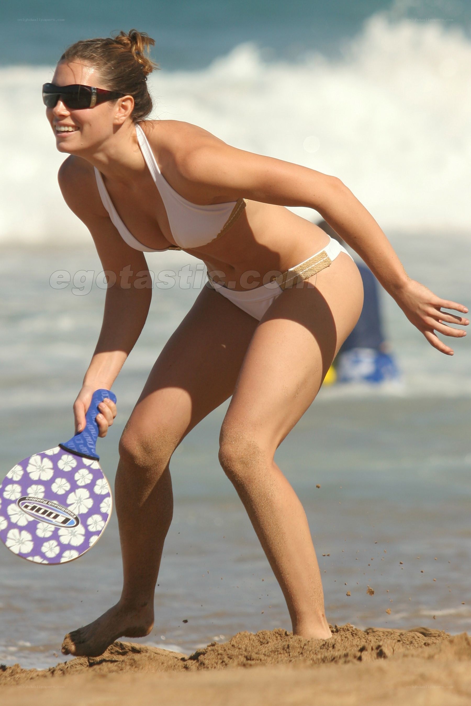 Woman playing beach paddleball