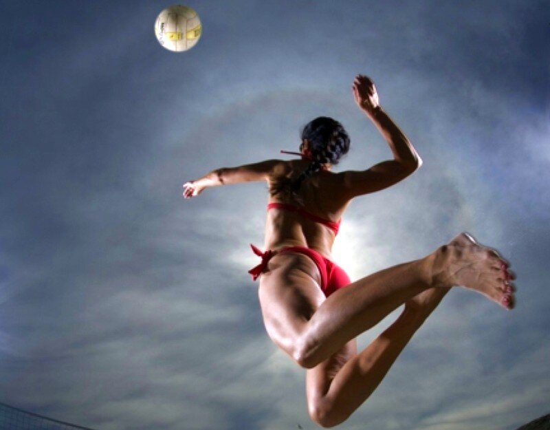 woman playing beach volleyball