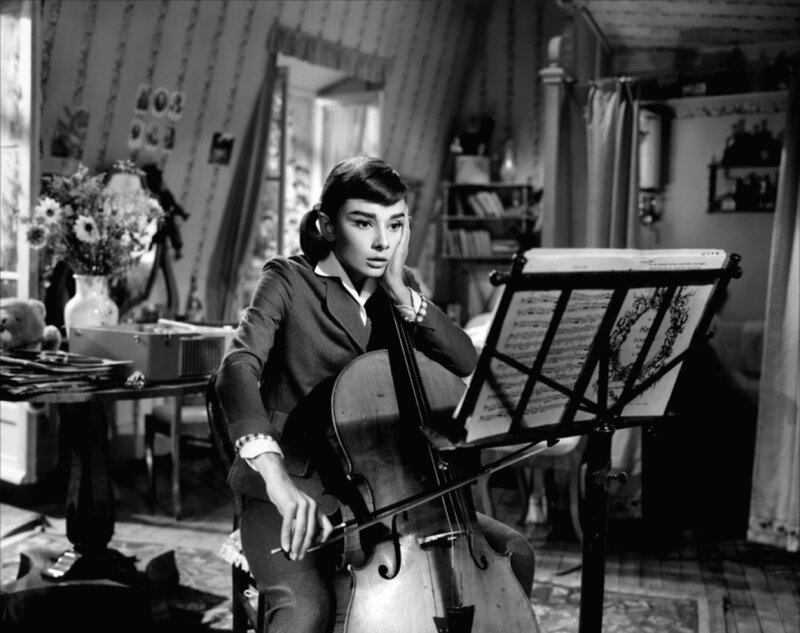 woman playing cello at home