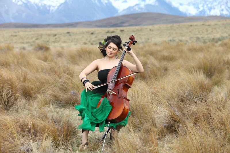 Woman playing cello in a field