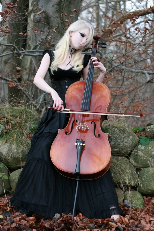 Woman playing cello in forest