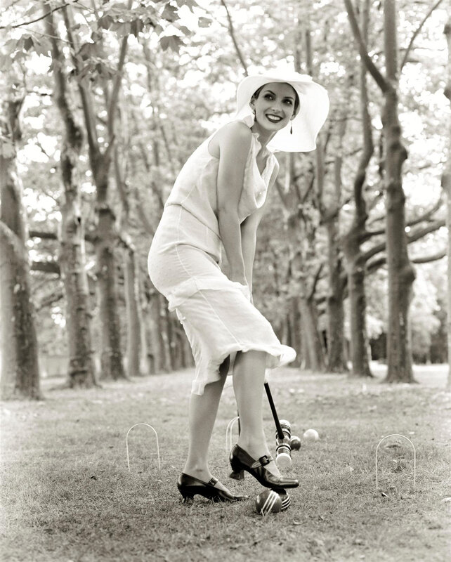 Woman playing croquet in garden