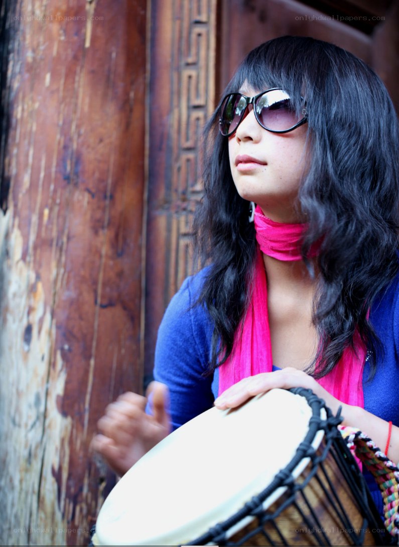 woman playing djembe drum