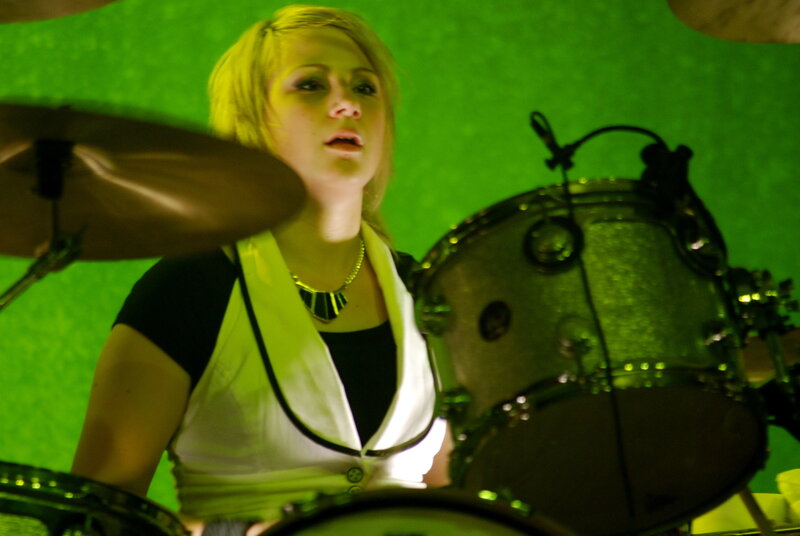 Woman playing drums on stage