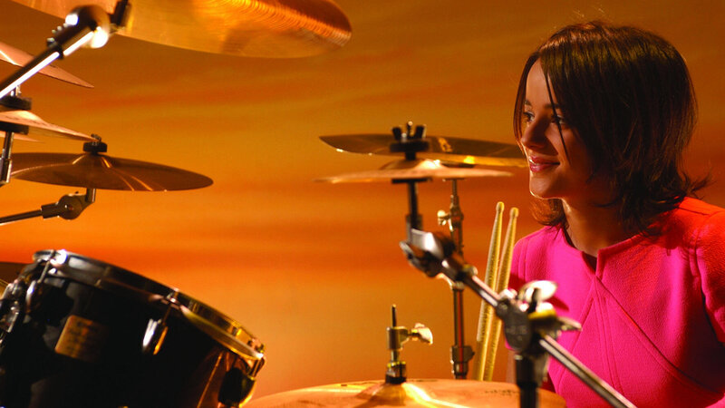 woman playing drums on stage