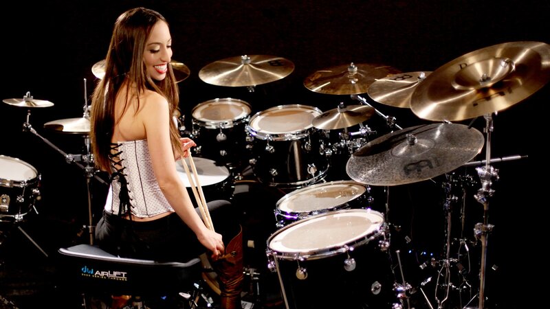 woman playing drums on stage