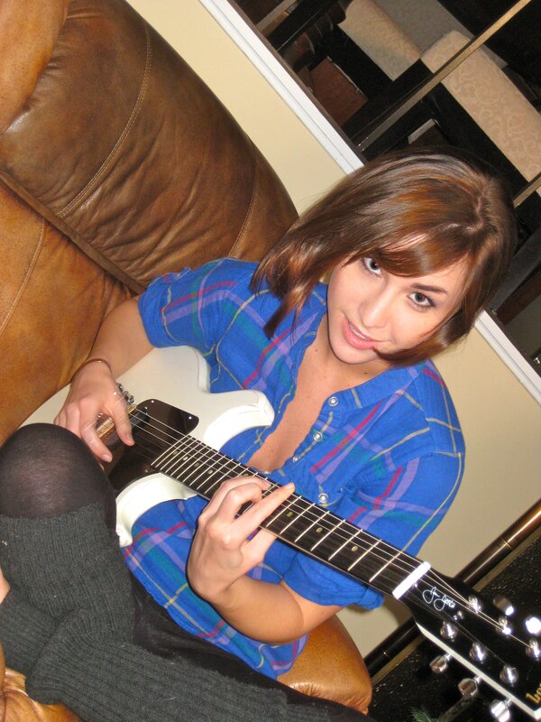 woman playing electric guitar
