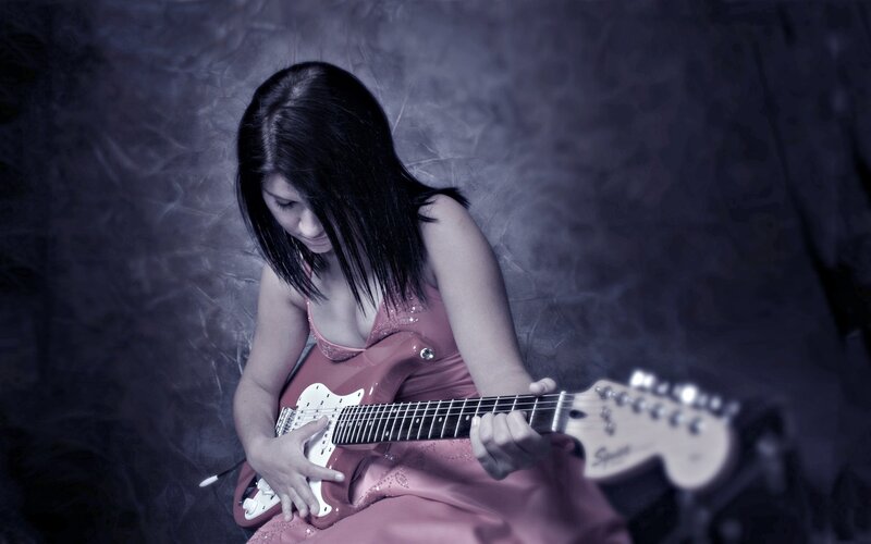woman playing electric guitar
