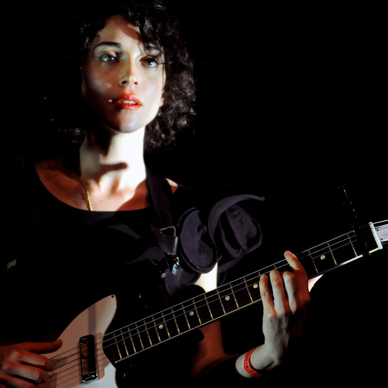 woman playing electric guitar