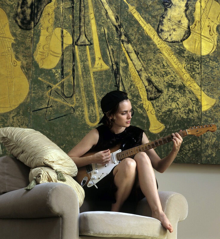 Woman playing electric guitar
