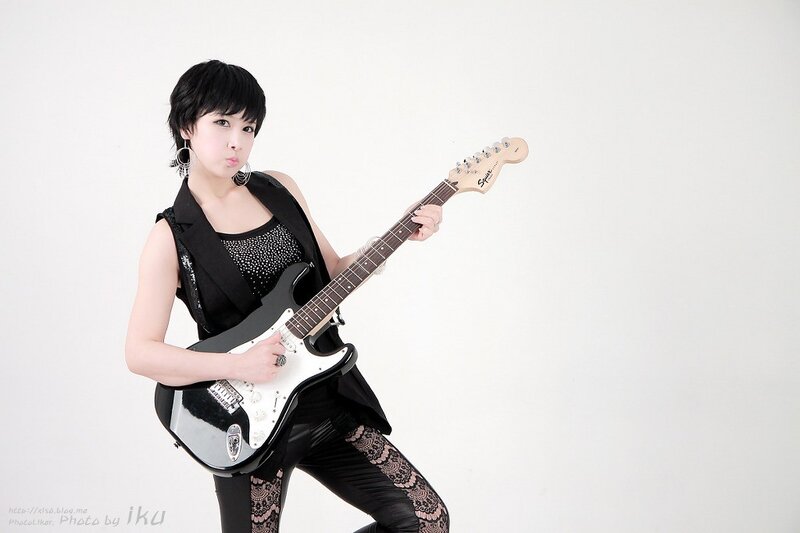 woman playing electric guitar