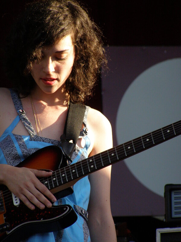 woman playing electric guitar