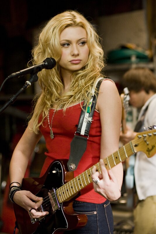 woman playing electric guitar