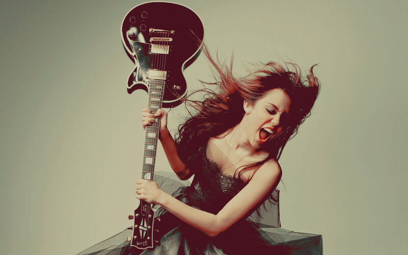 woman playing electric guitar