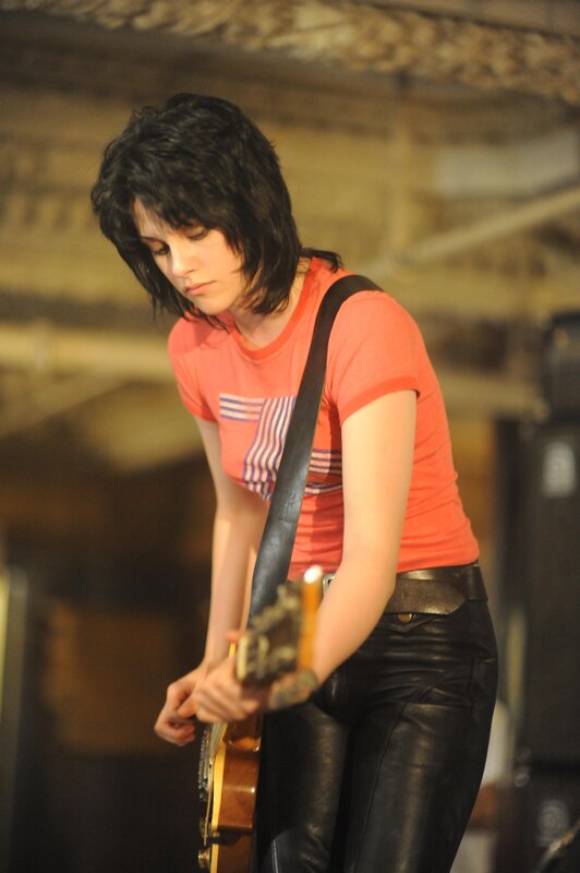 woman playing electric guitar