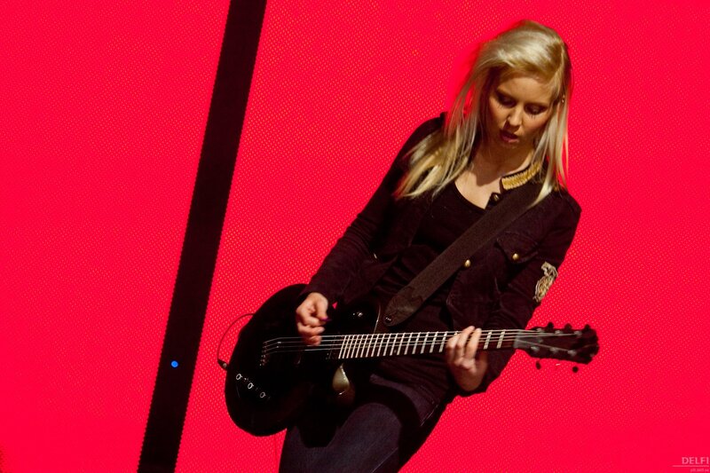 Woman playing electric guitar on stage