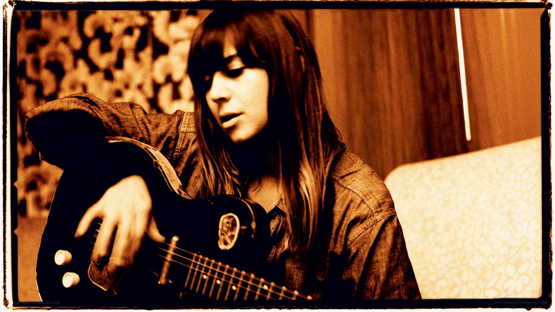 woman playing electric guitar