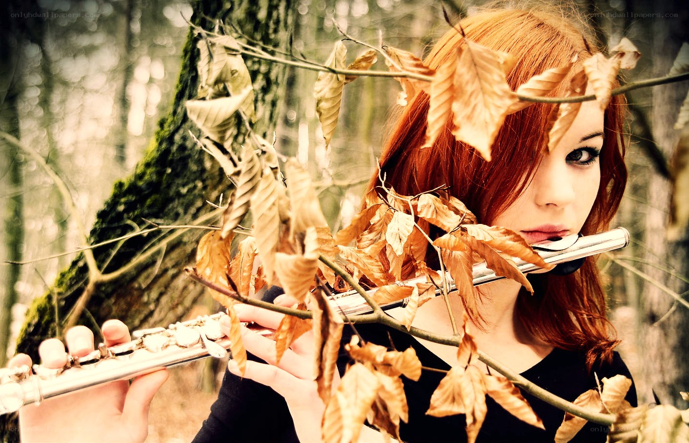 Woman playing flute in forest