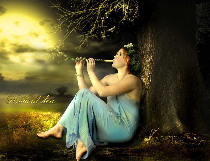 Woman playing flute in moonlight