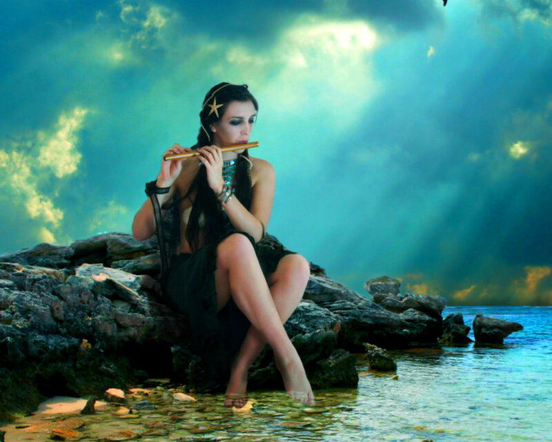 Woman Playing Flute on Rocks