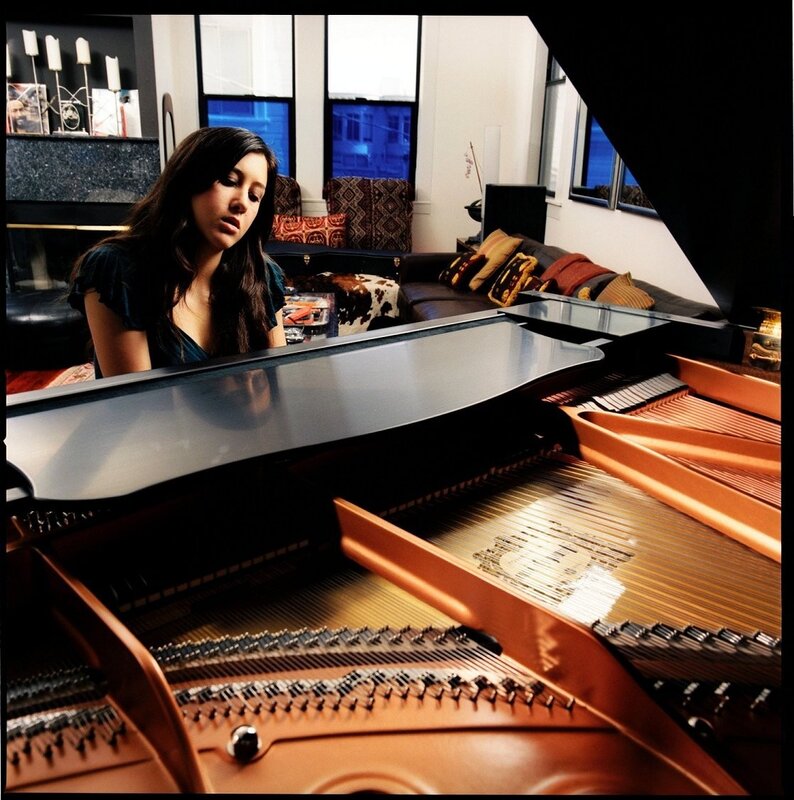 woman playing grand piano