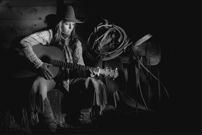 Woman Playing Guitar — Black, Dramatic, Night, Photograph, Saddle