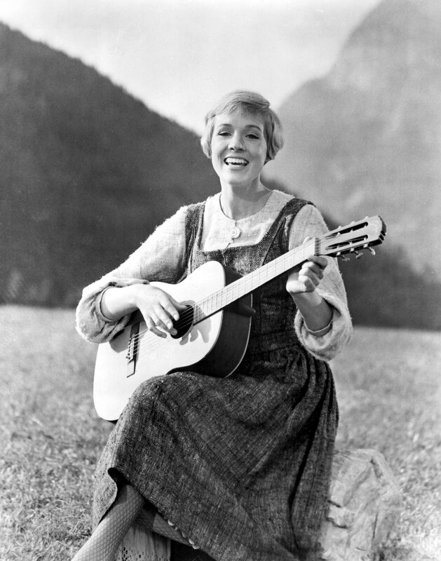 Woman playing guitar in a field