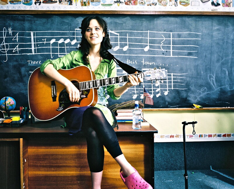Woman playing guitar in classroom
