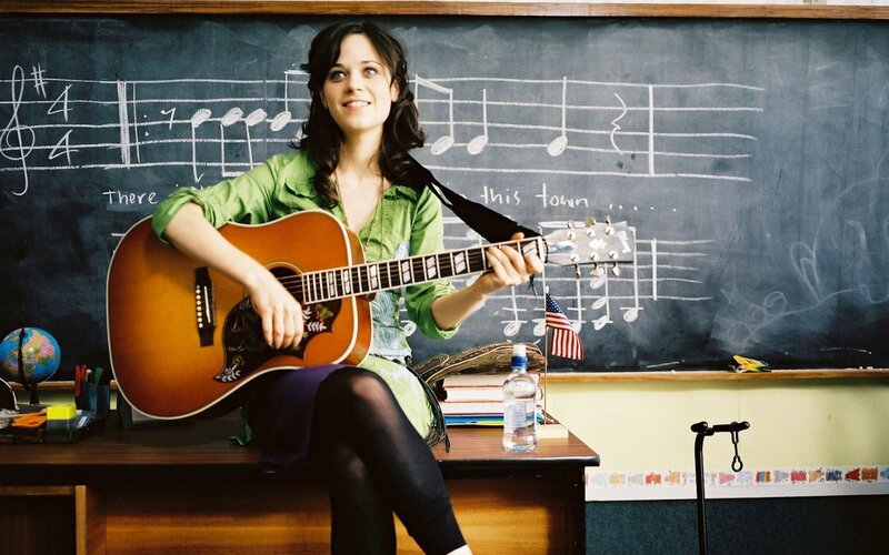 woman playing guitar in classroom