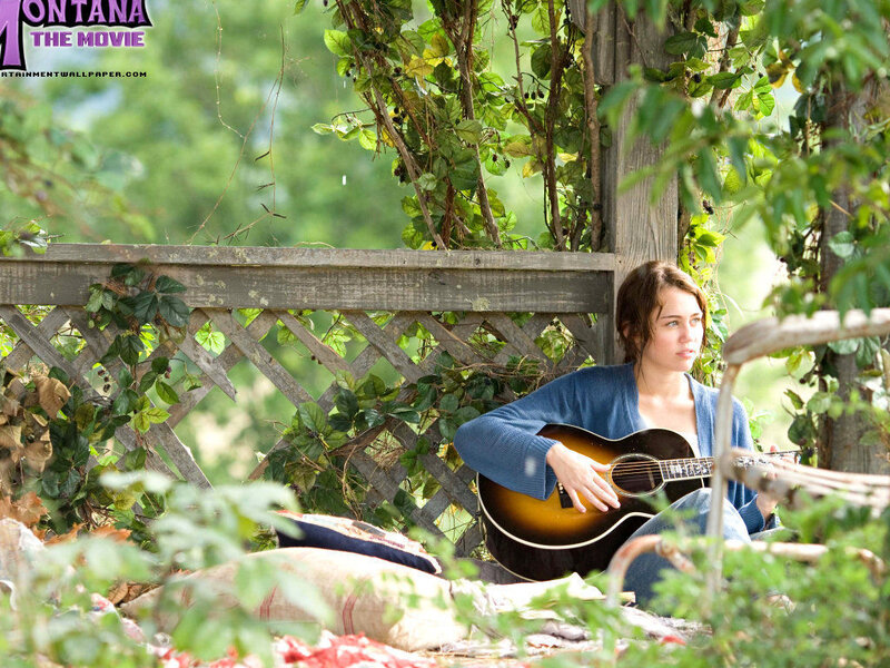 Woman playing guitar in garden